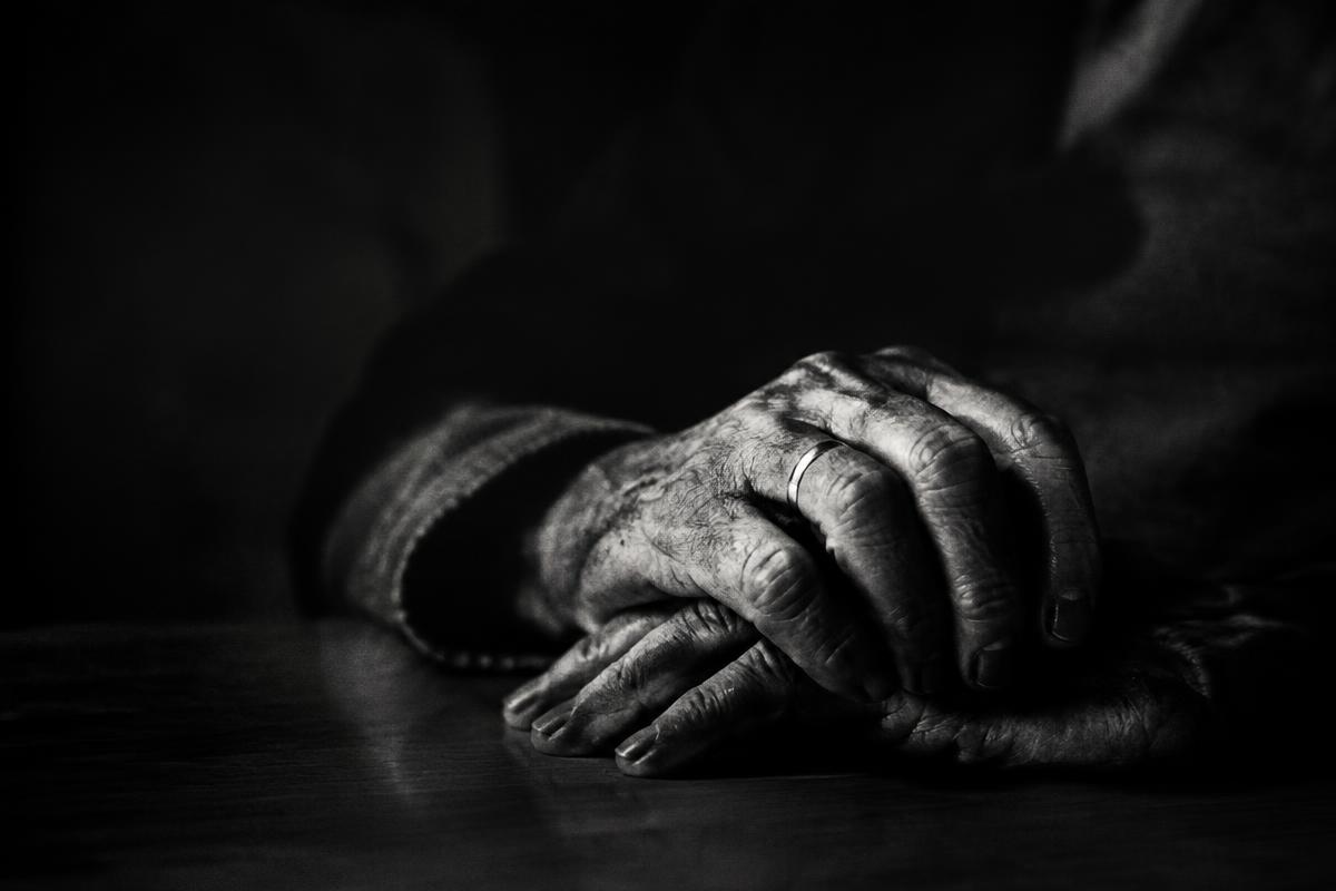 Hands resting in low light